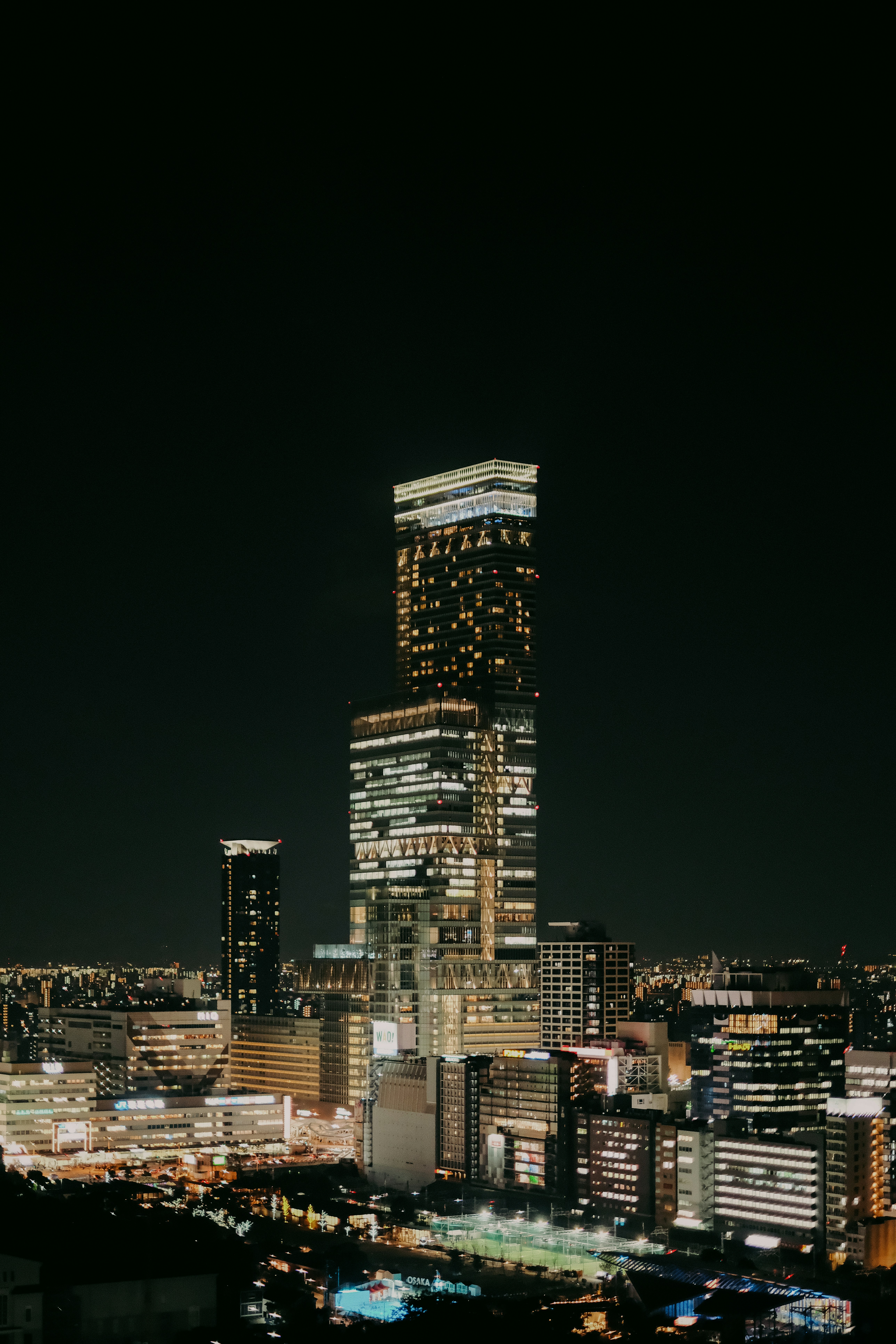 Illuminated skyscrapers in a city at night.