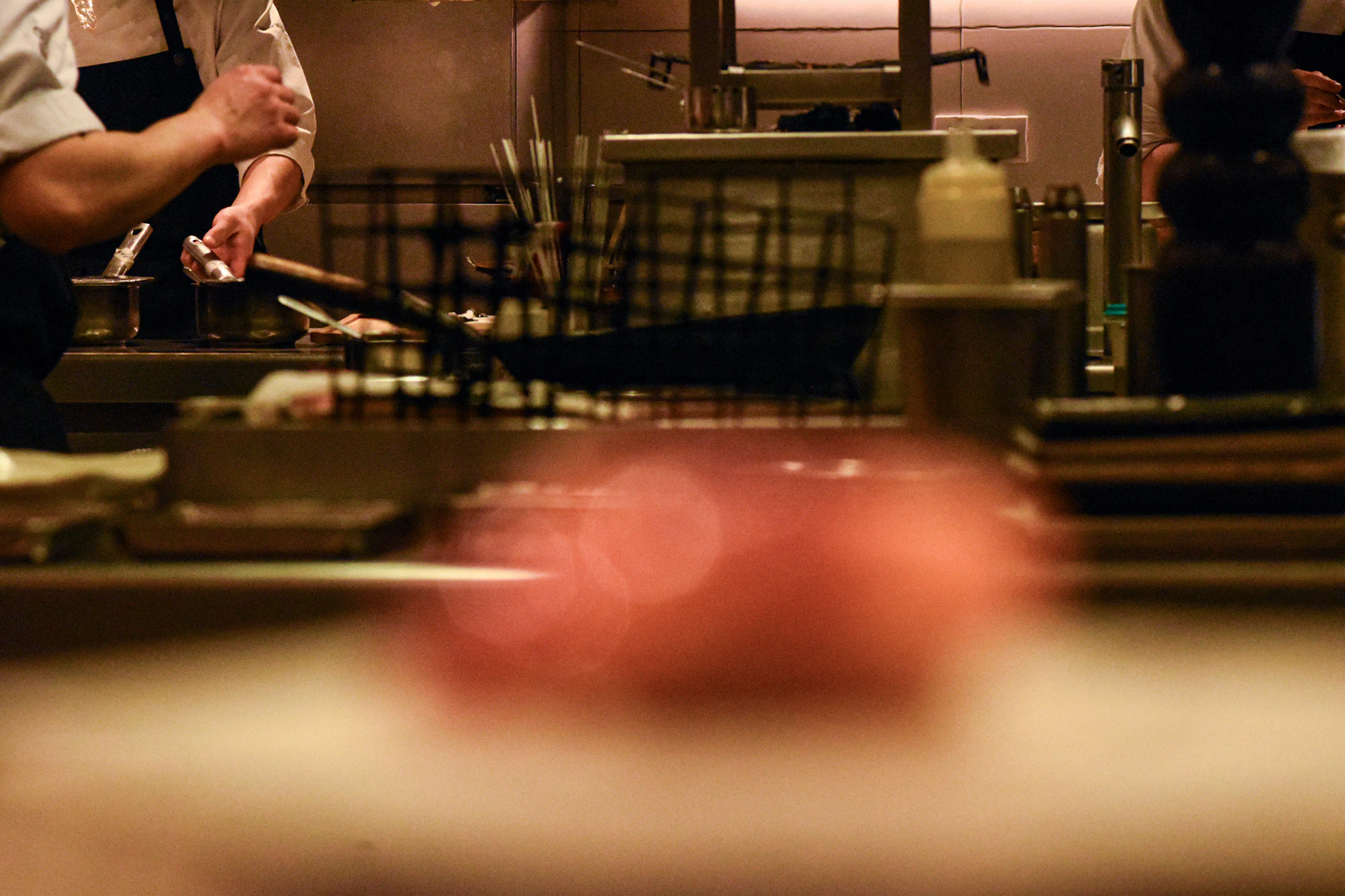 Chefs plating tickets during service on a busy kitchen line