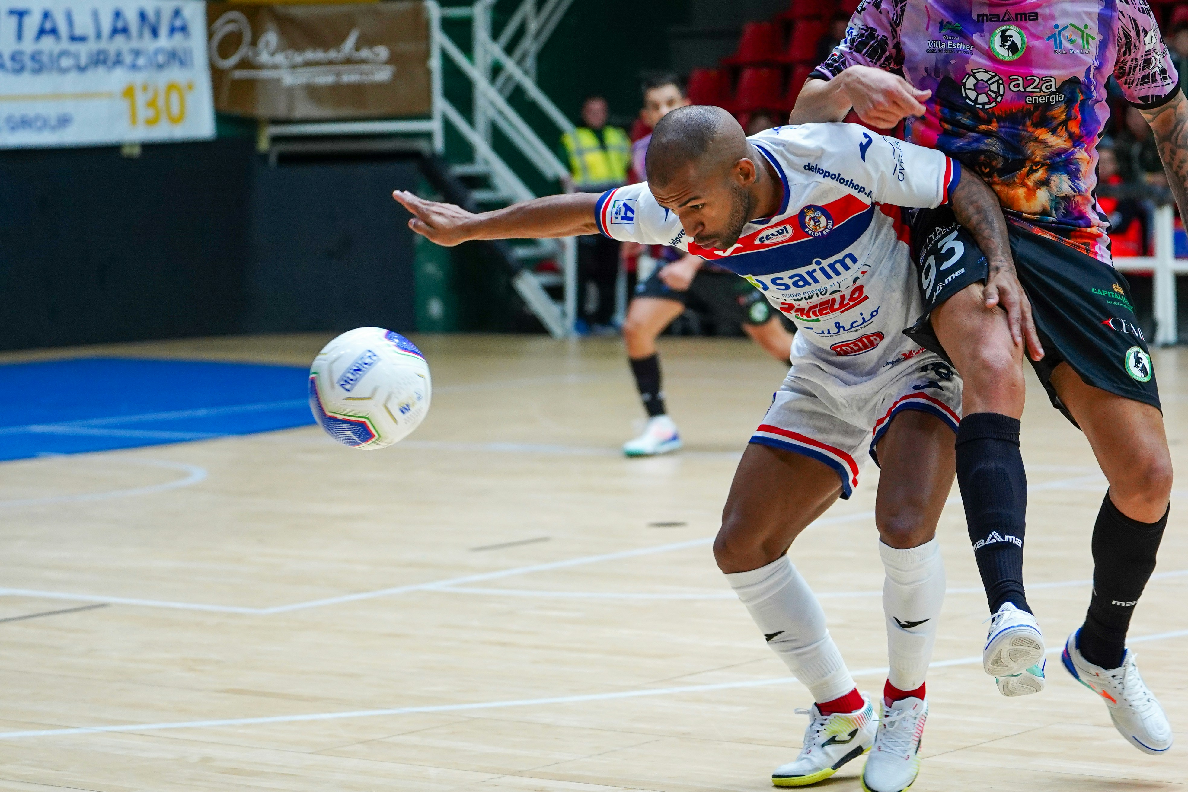 Two soccer players competing for the ball