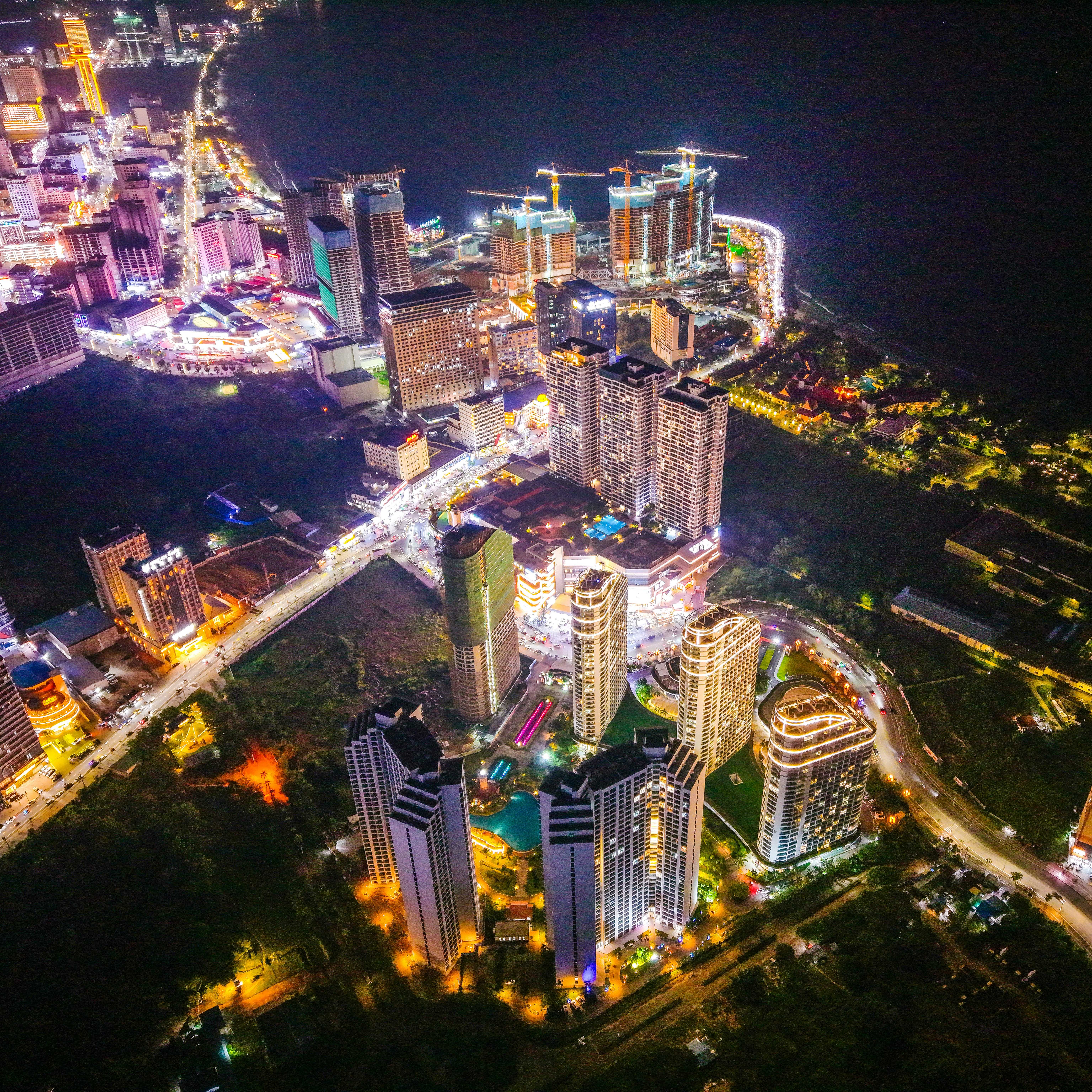 Aerial view of a modern city skyline at night.