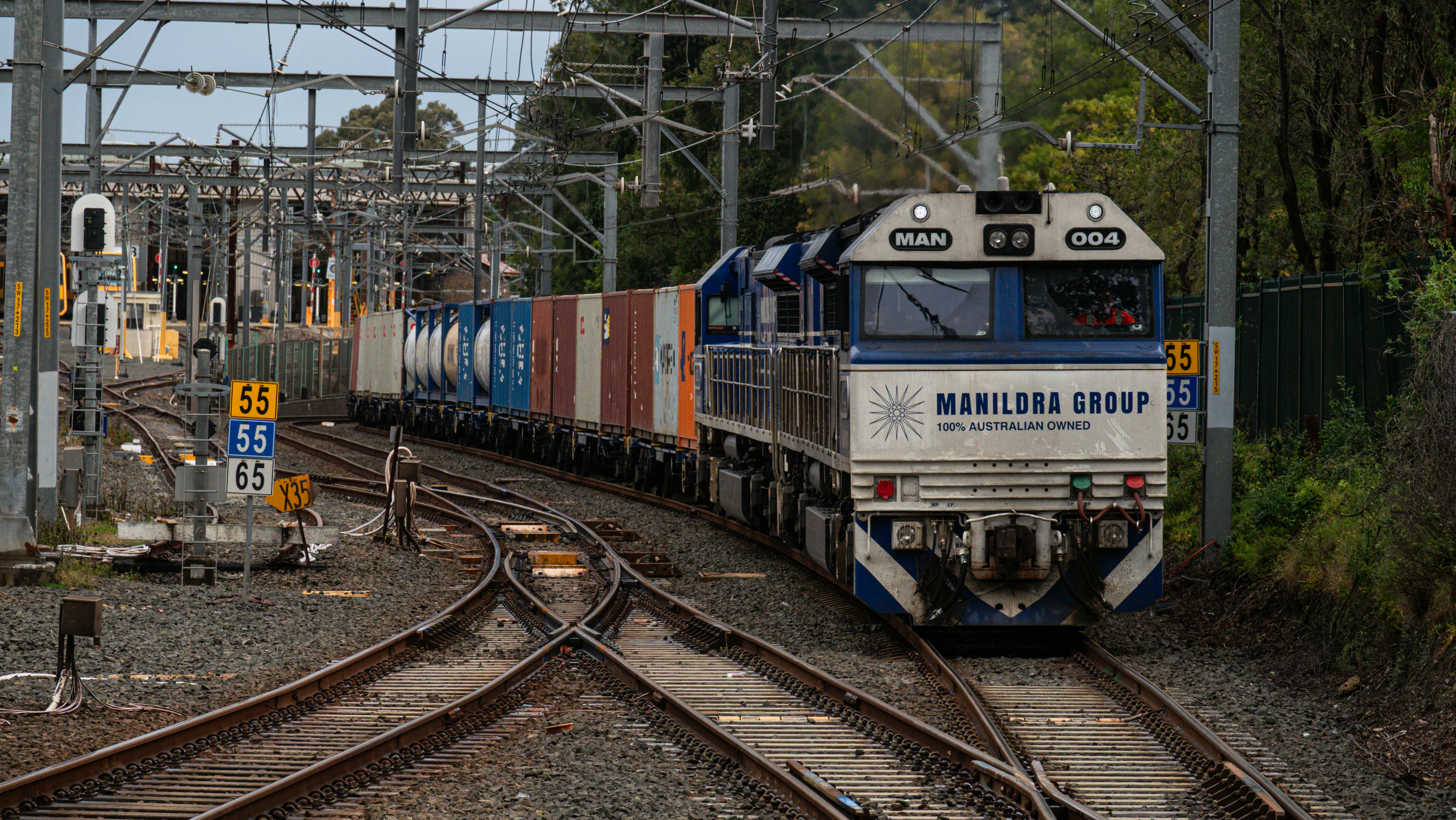 A freight train with shipping containers on tracks.