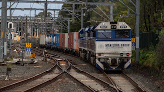 A freight train with shipping containers on tracks.