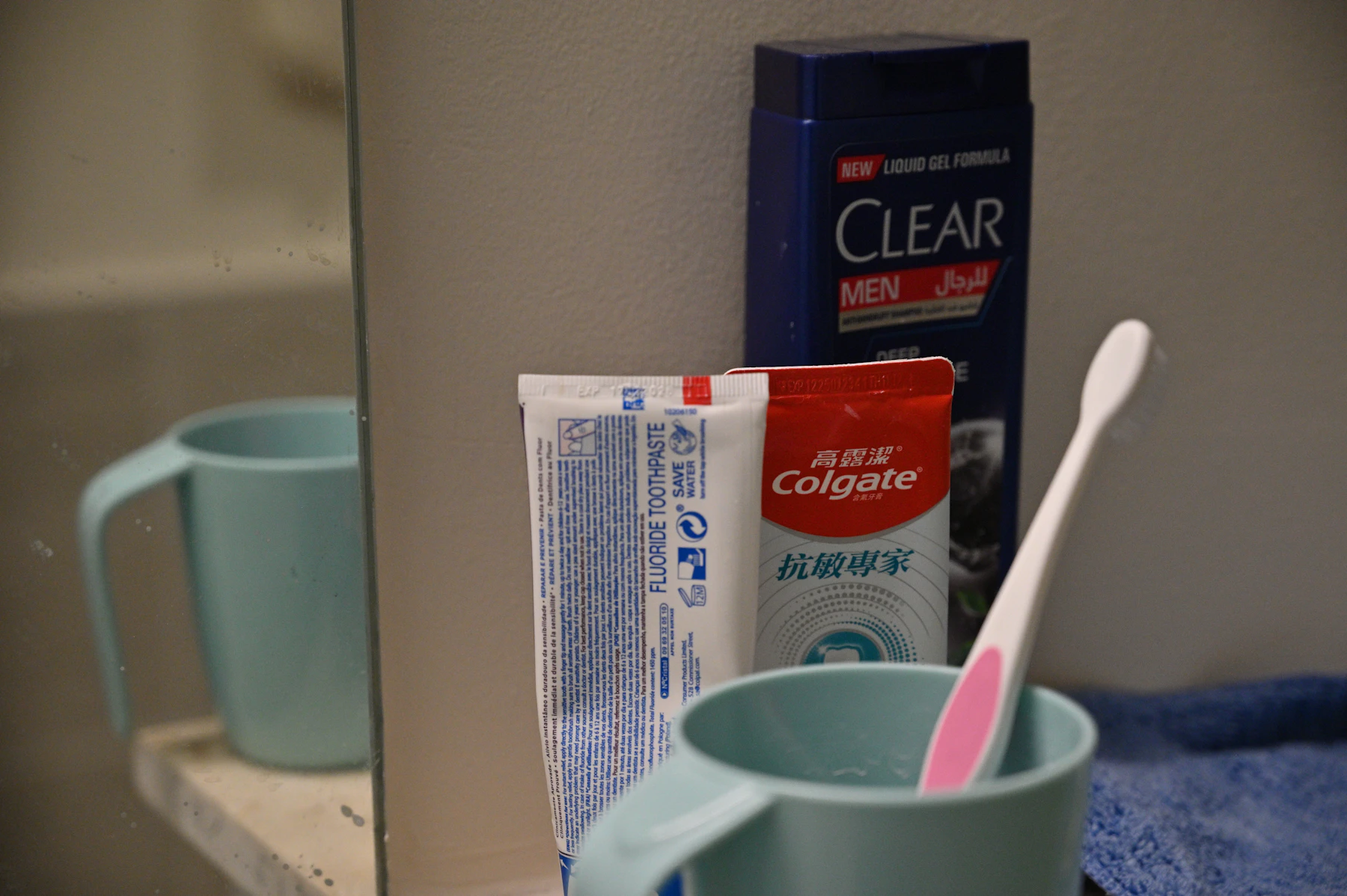 Toothbrush, toothpaste and personal hygiene products arranged on a bright bathroom counter