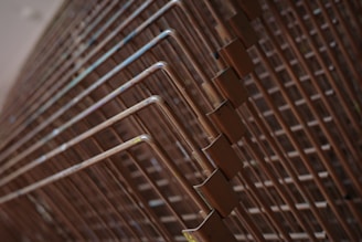 Stacked copper pipes form geometric patterns