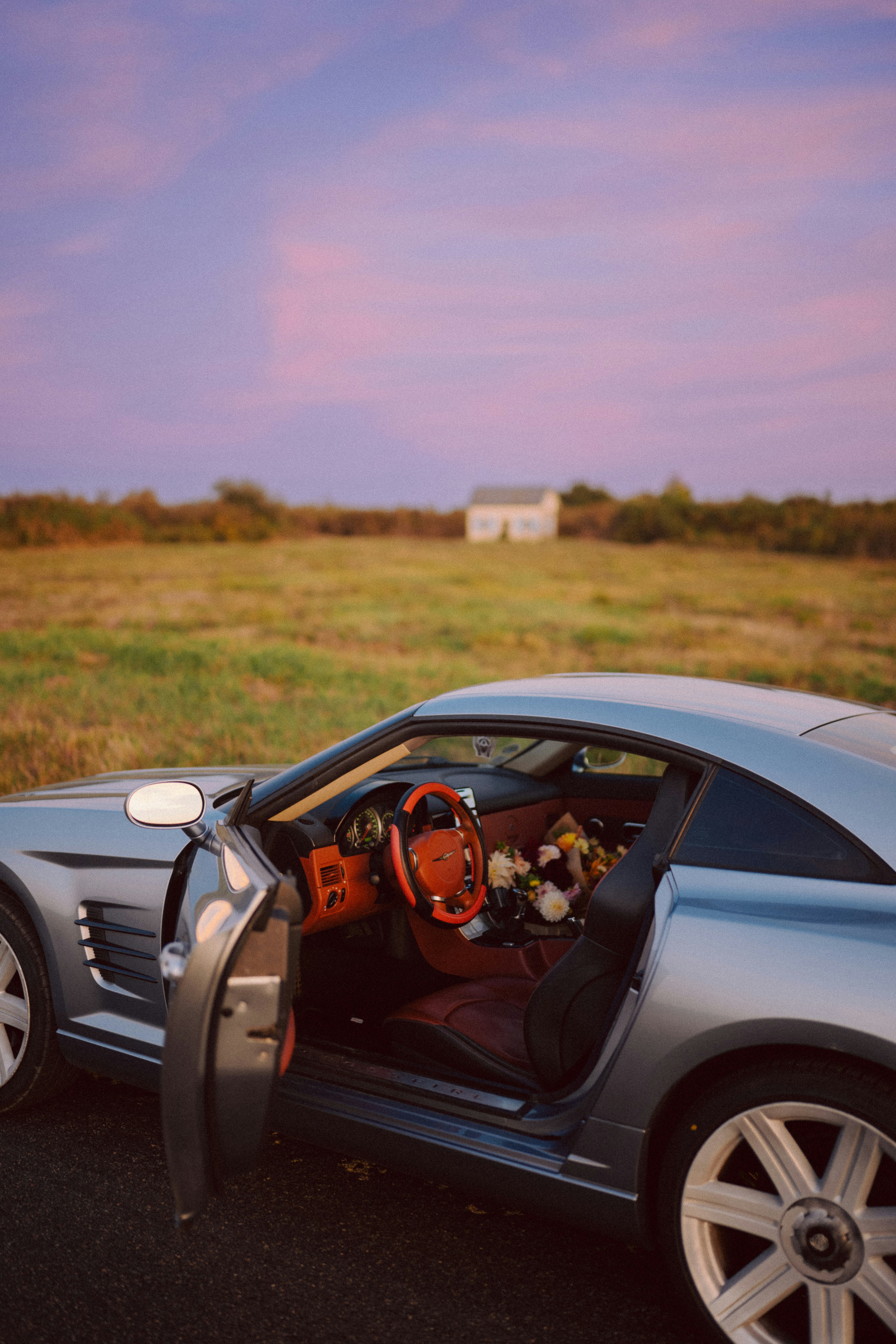 Luxury car with flowers on the passenger seat.