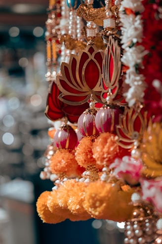 Close-up of colorful indian festival garlands with lotus charms.