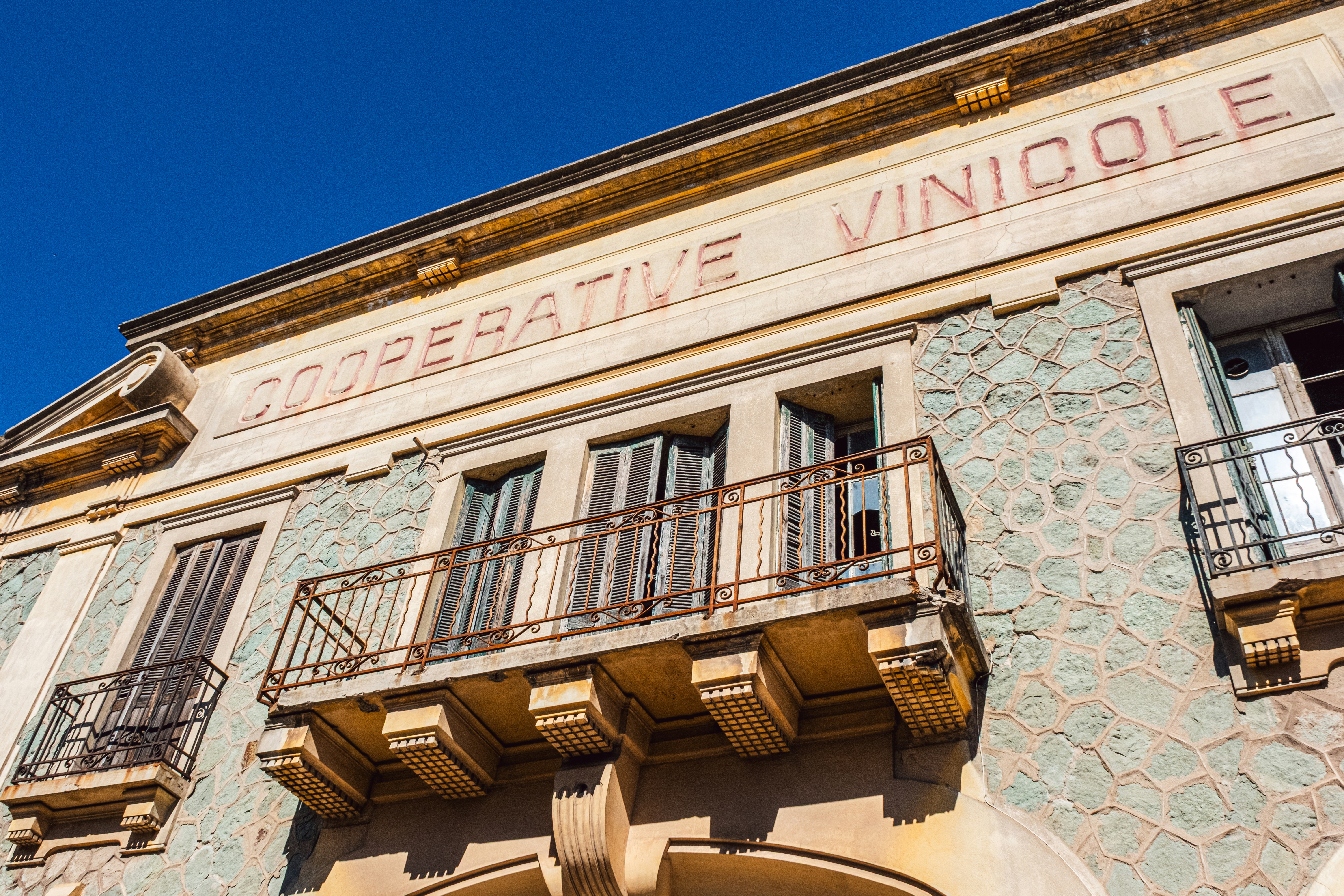 Cooperative vinicole building facade with balconies