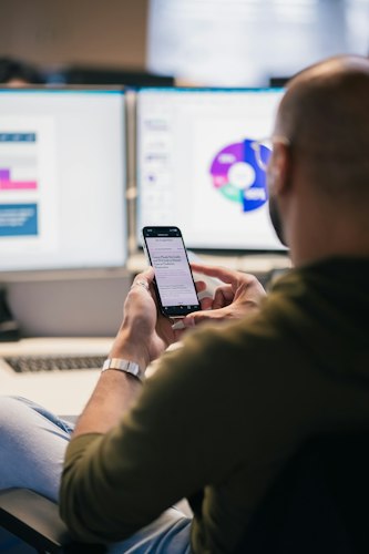 A person using a smartphone with screen-reader accessibility features enabled