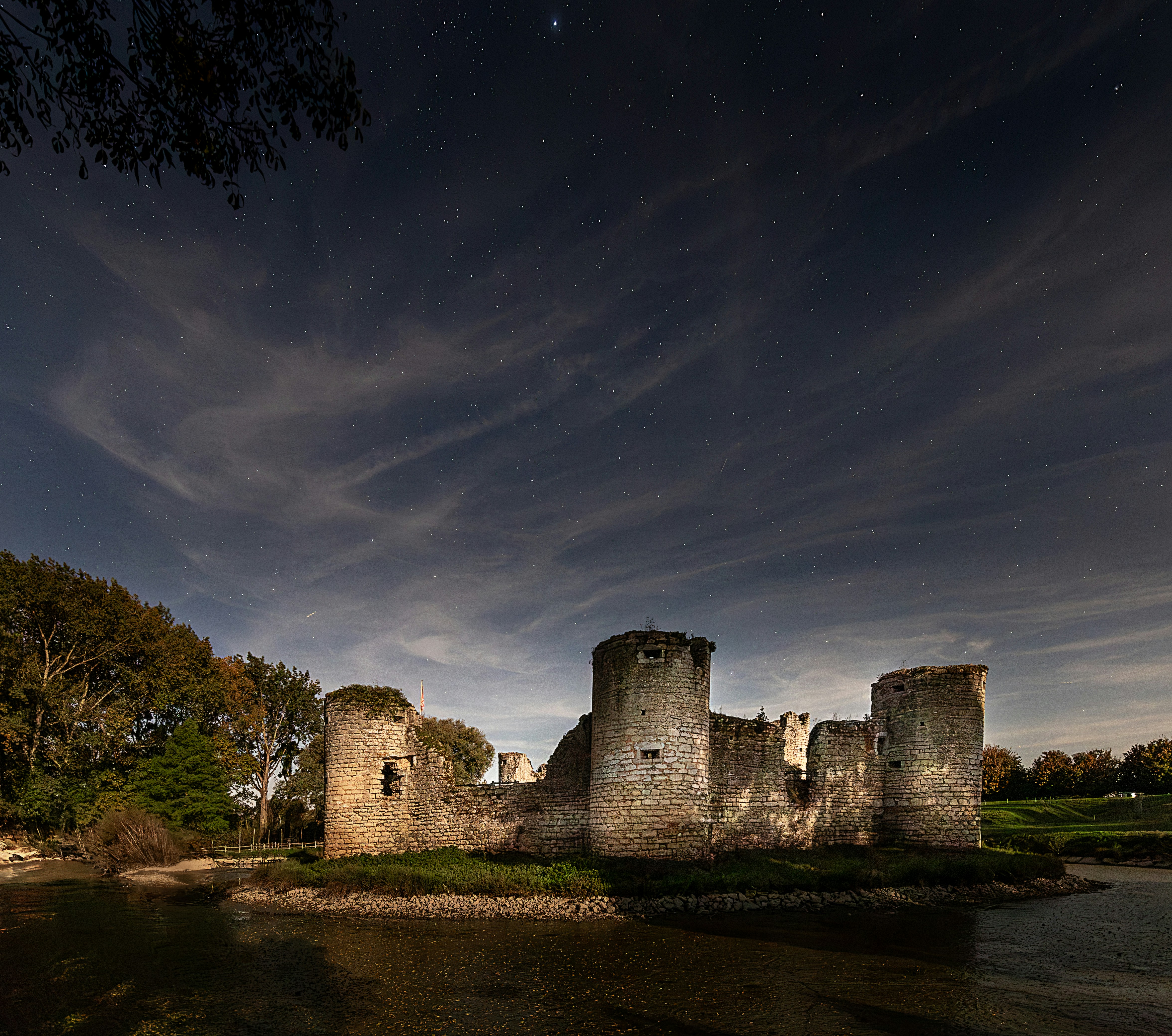 Ancient castle ruins under a starry night sky