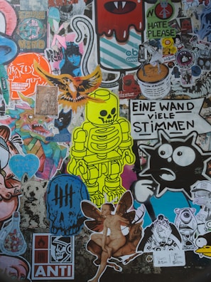 A collage of colorful and diverse stickers on a wall.