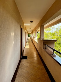 Long hallway with doors and outdoor view