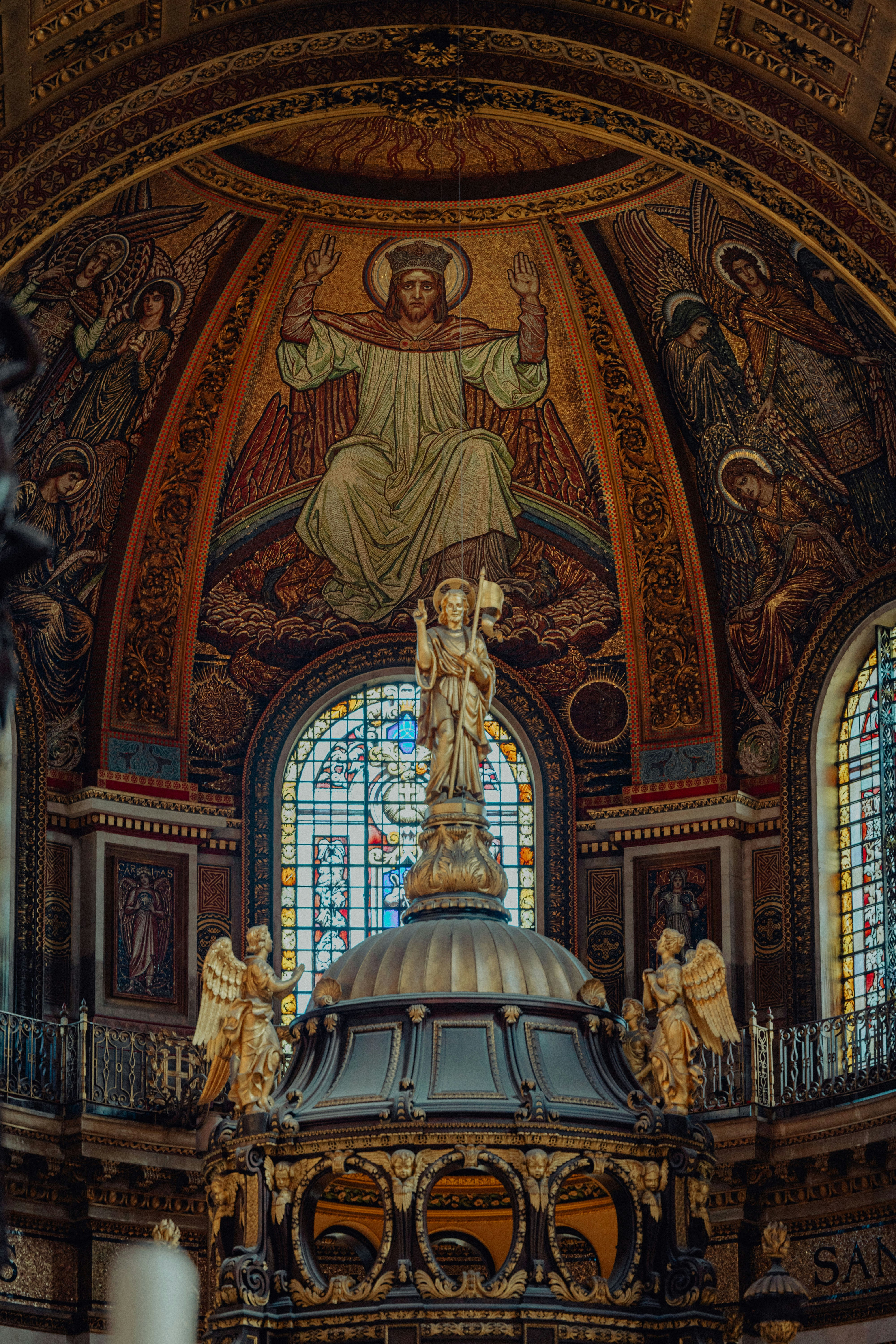 Intricate mosaic and stained glass inside a grand church