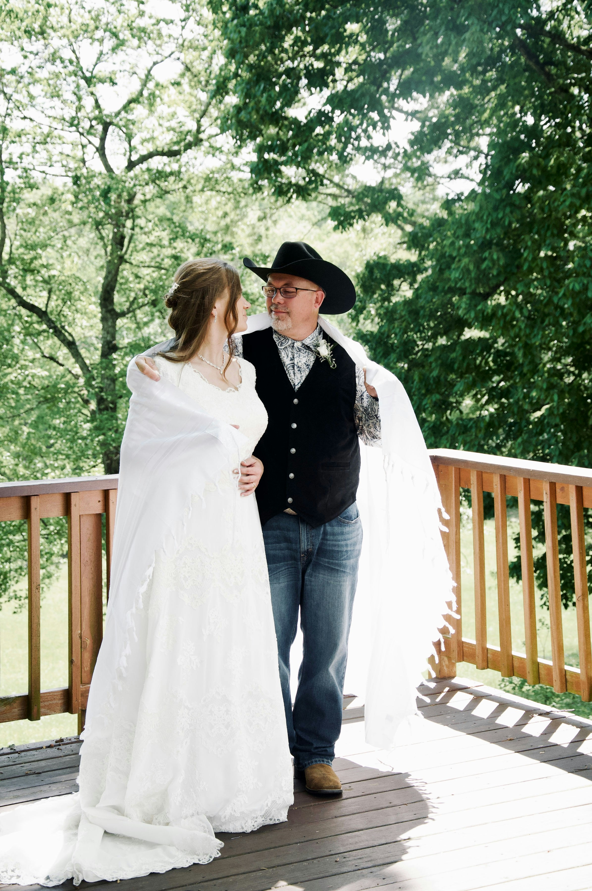 Bride and father on a wooden deck