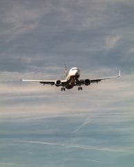 A commercial airplane flying in a cloudy sky