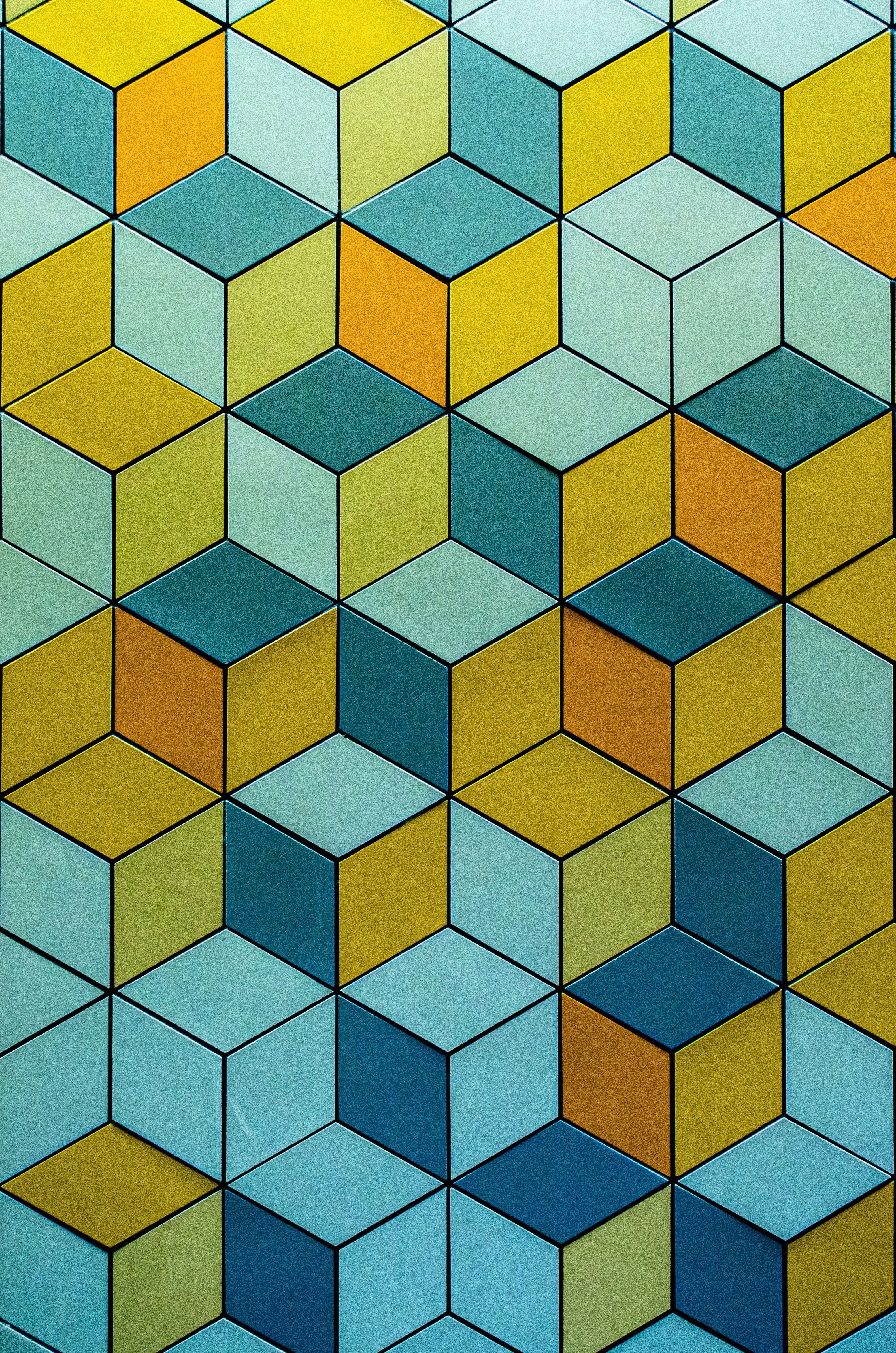 Colorful geometric cube pattern in yellow, blue, and teal.