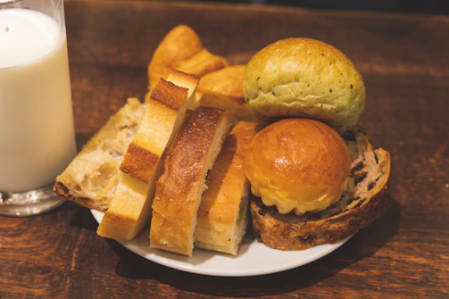 Assortment of breads and a glass of milk