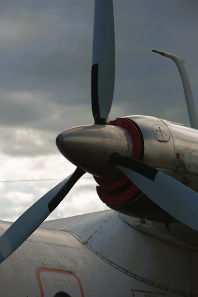 Close-up of an airplane propeller against cloudy sky