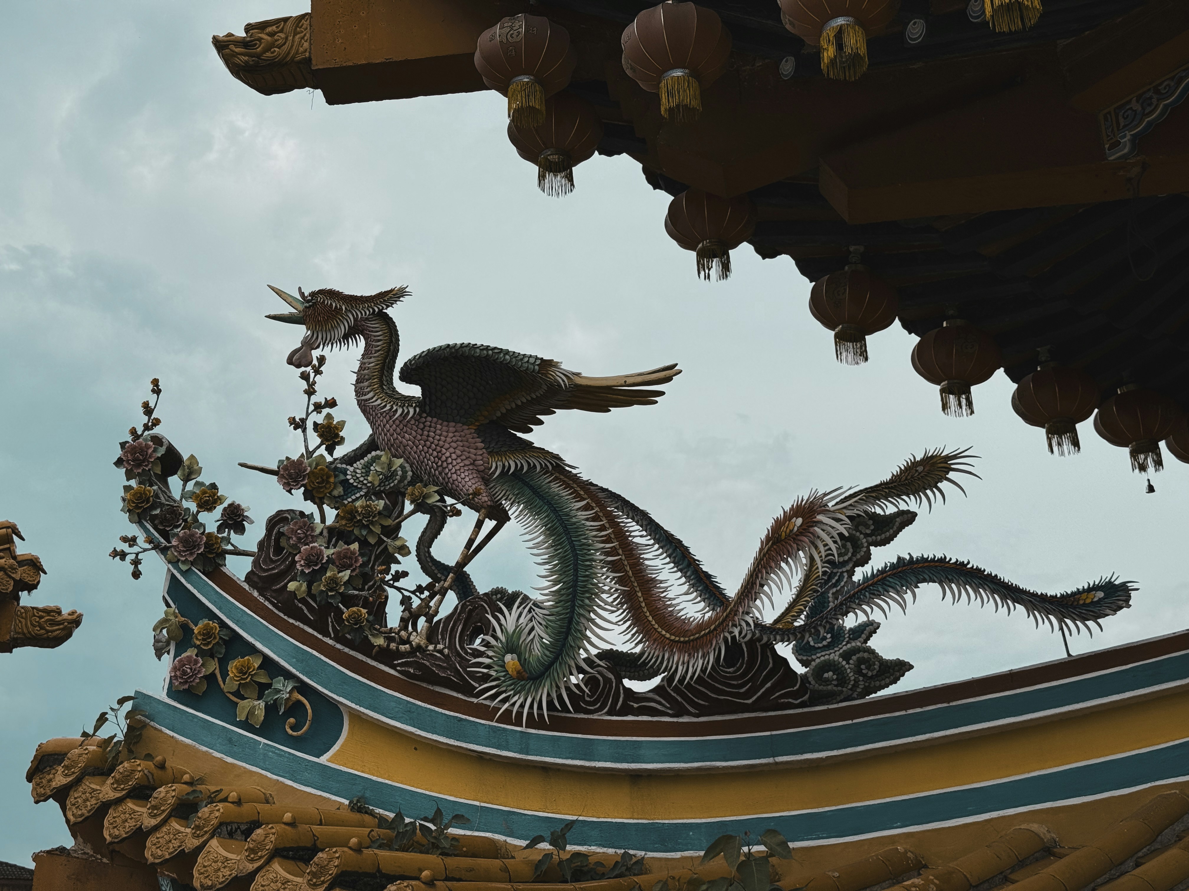 Ornate phoenix sculpture on a temple roof