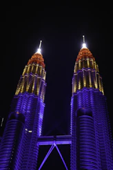 Petronas towers illuminated with colorful lights at night