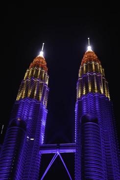 Petronas towers illuminated with colorful lights at night
