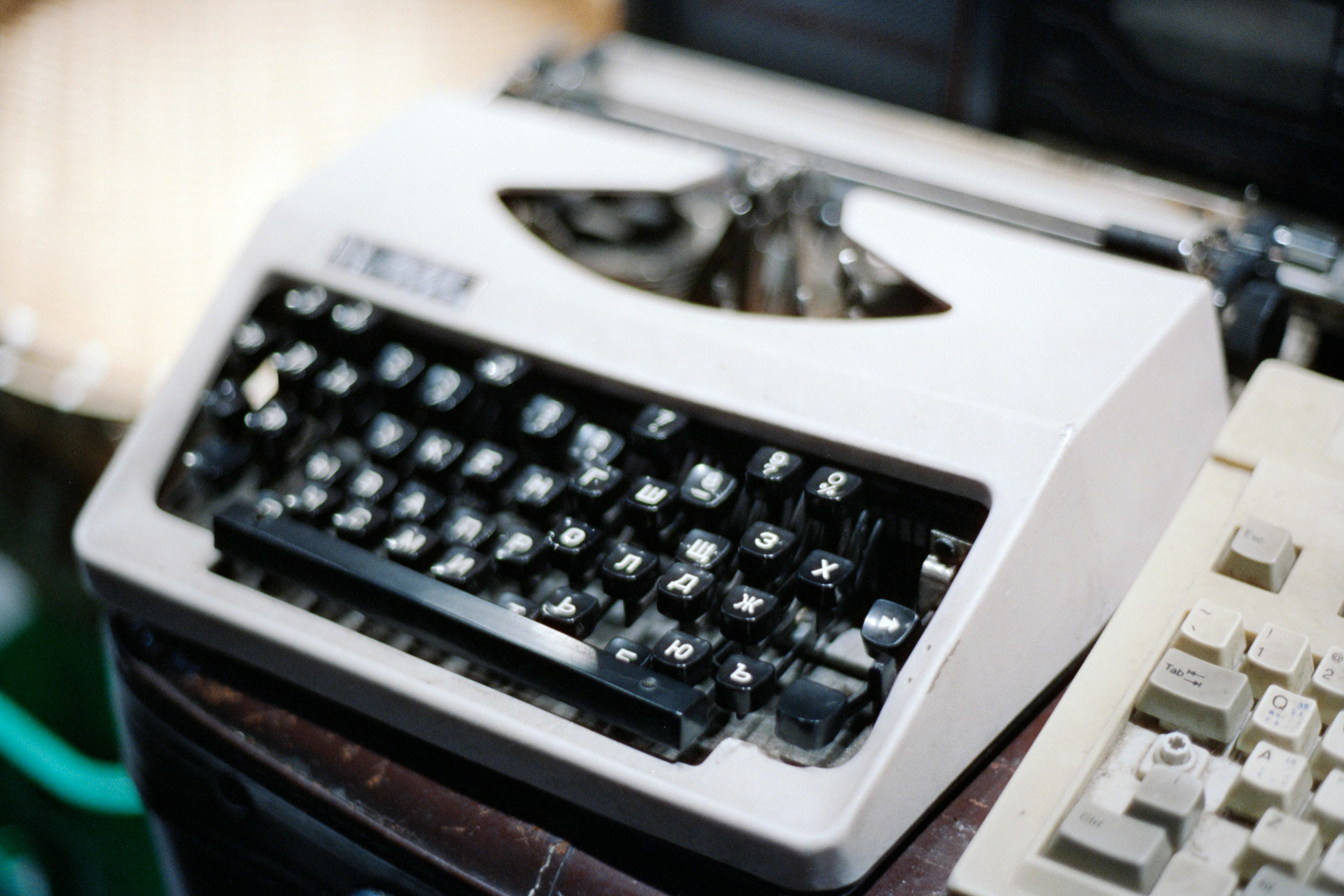 A vintage white typewriter with black keys.