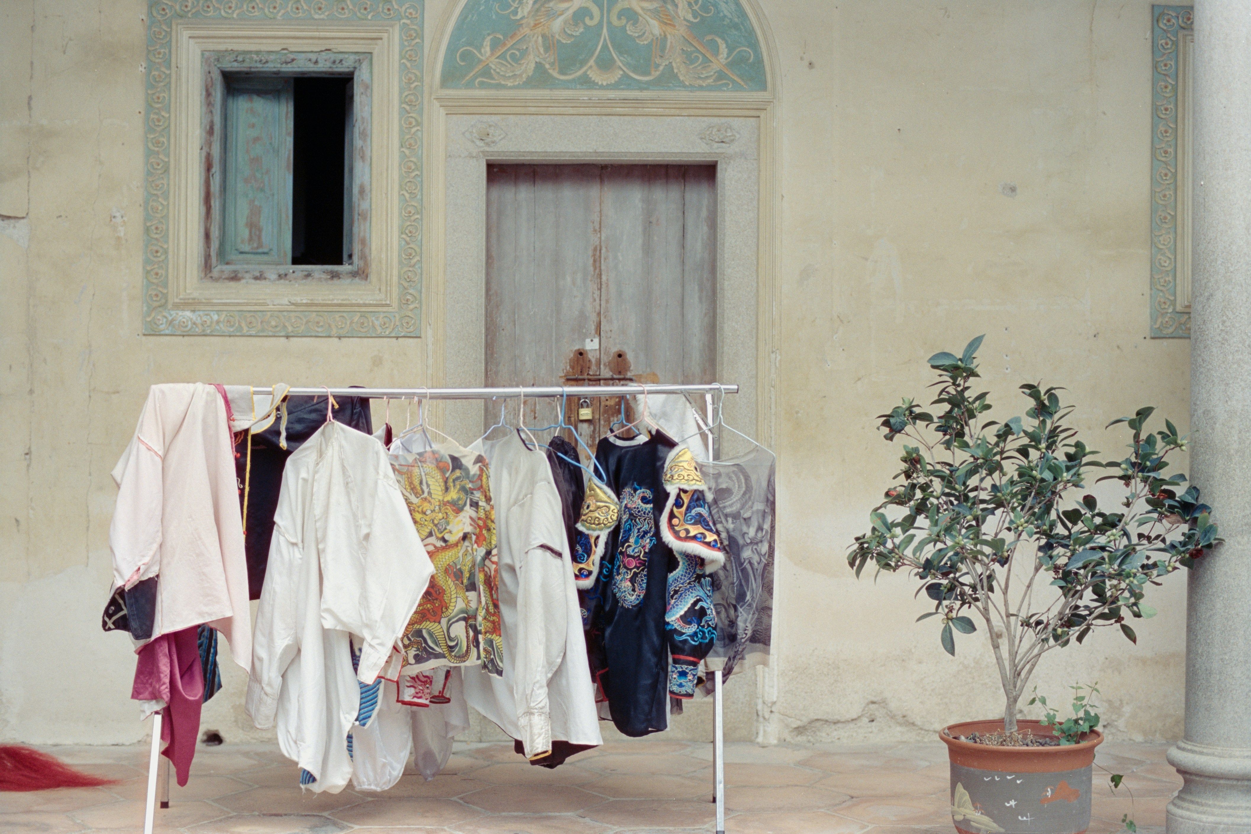 Clothes drying on a rack in a courtyard.