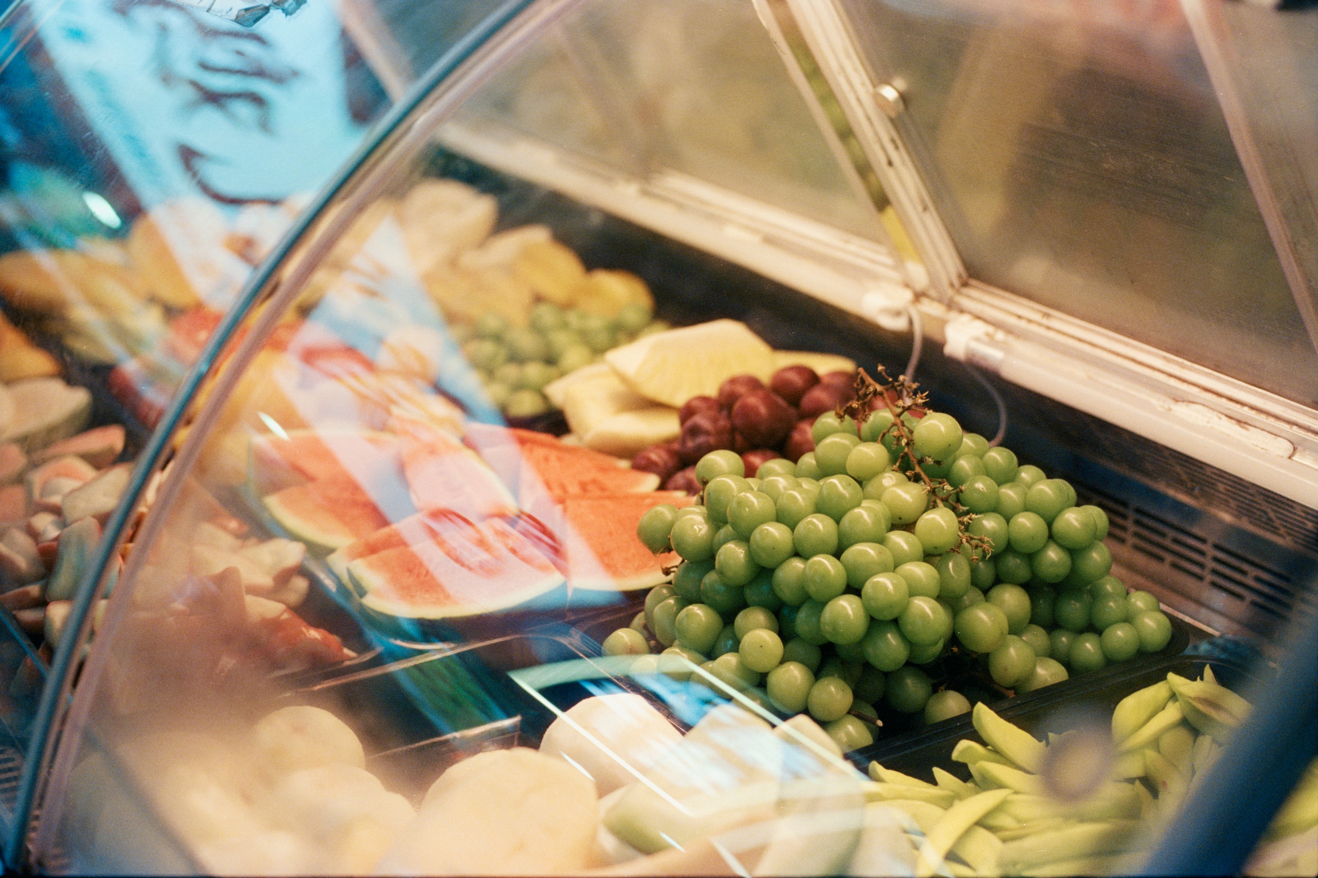 Fresh grapes and watermelon in display case