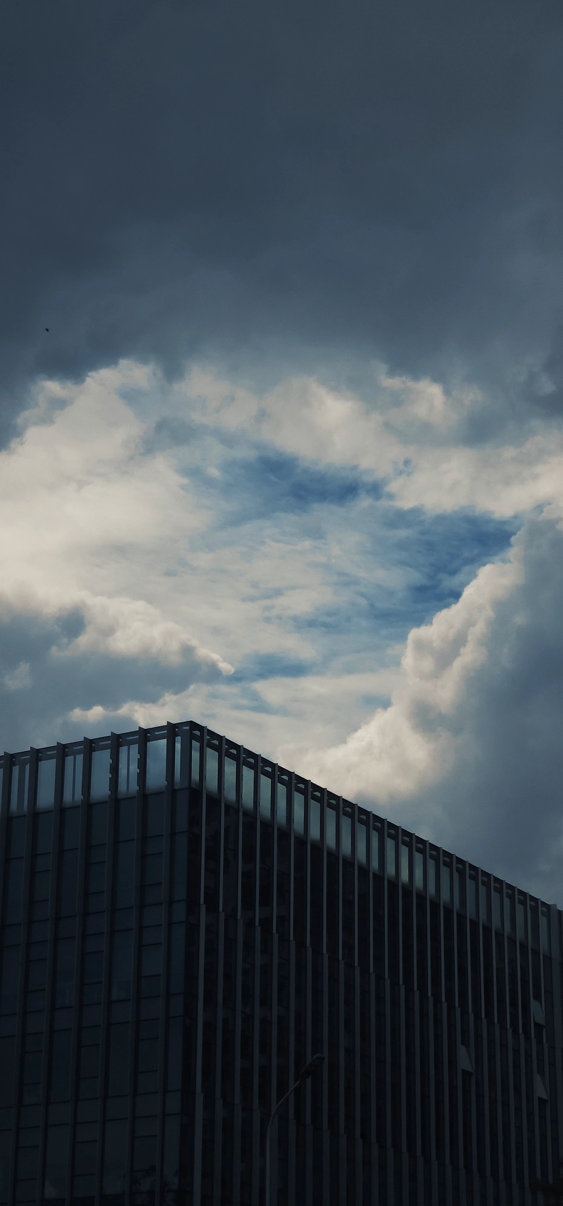 Modern building against a dramatic cloudy sky