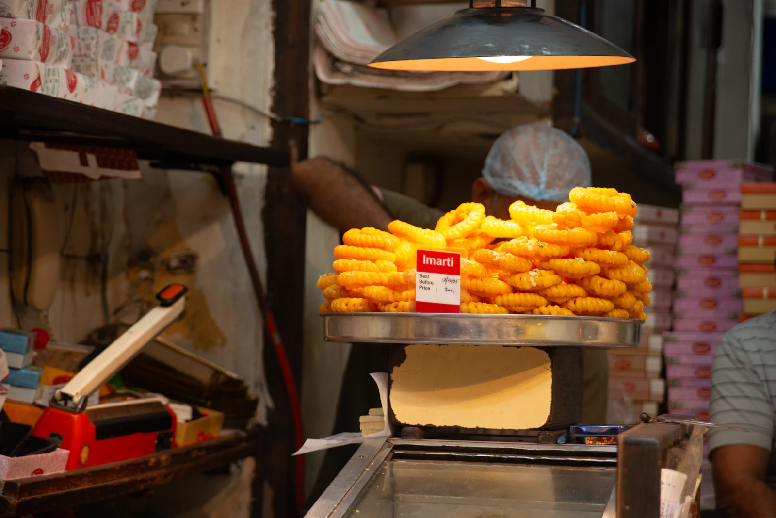 Jalebis being weighed on a scale