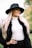 A woman wearing a hat and white turtleneck