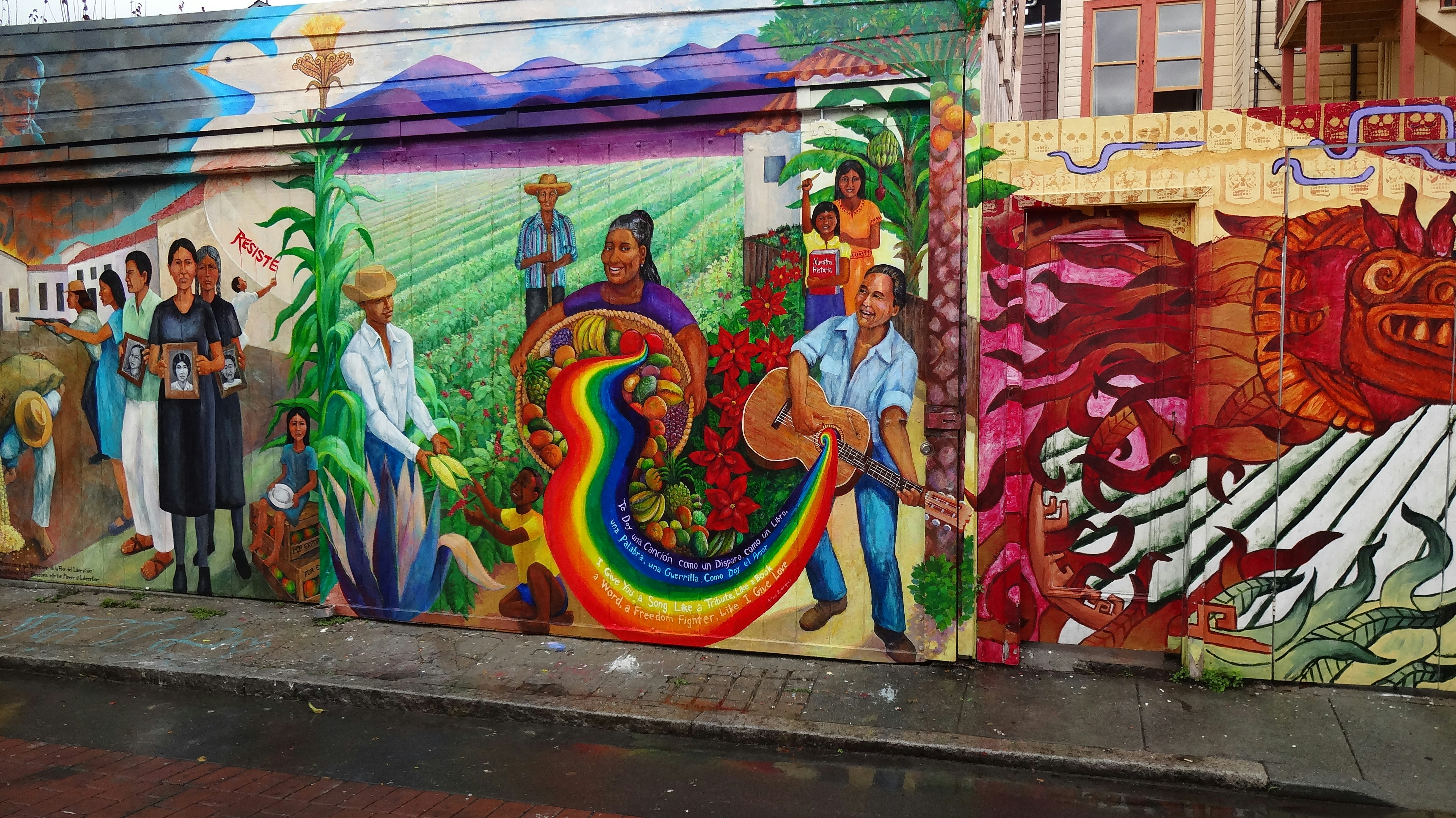 Colorful mural depicting people and cultural scenes
