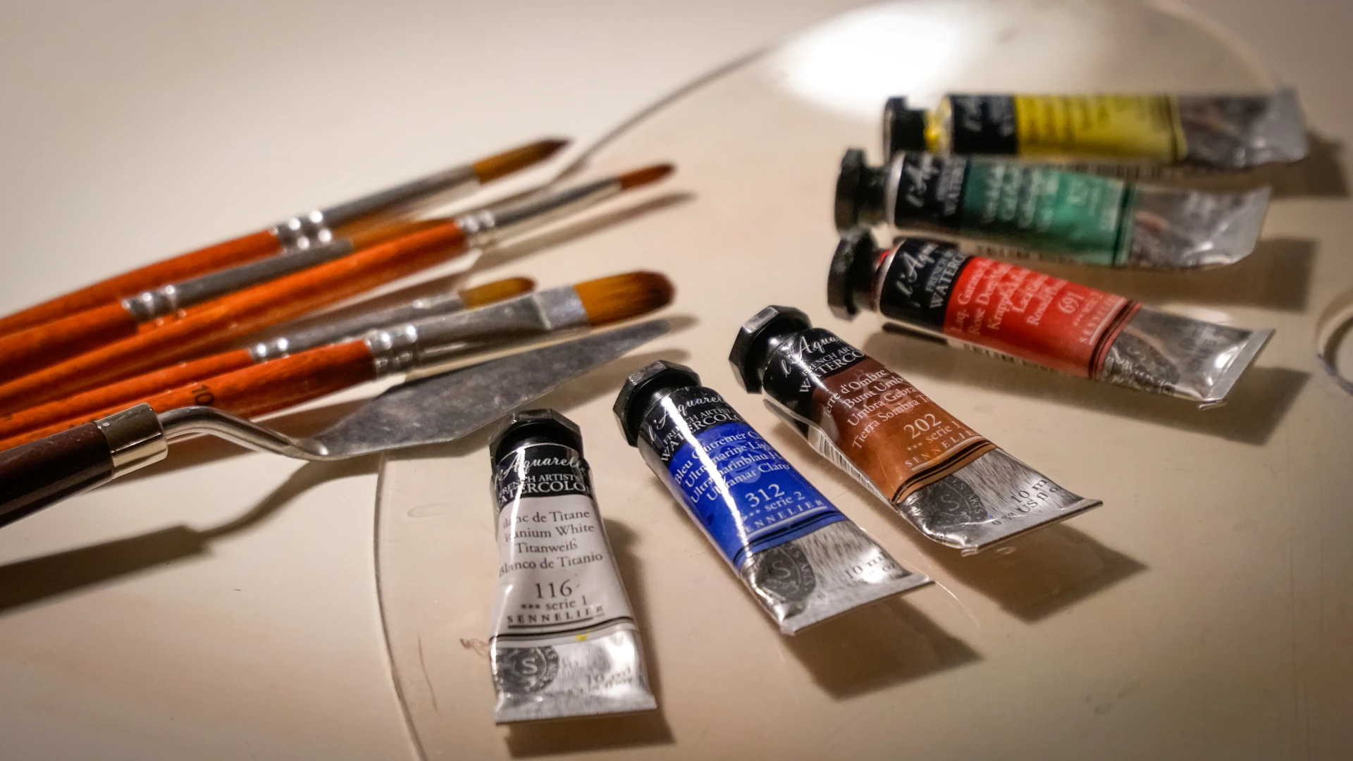 Artist's paint tubes and brushes on a palette