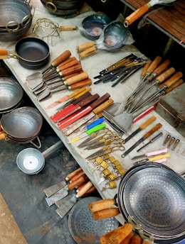 Assortment of kitchen utensils and cookware displayed on a table.