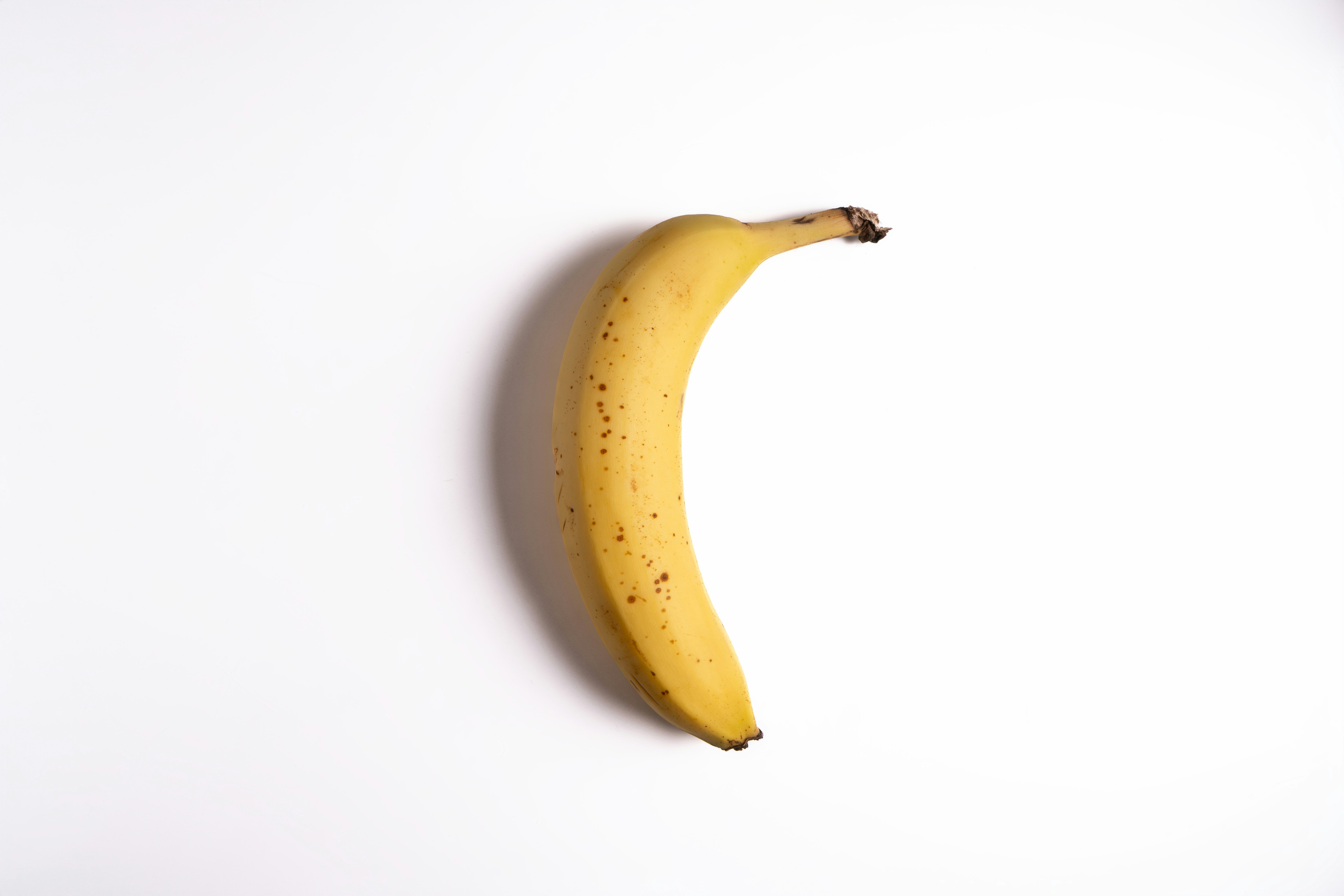 A single ripe banana on a white background.