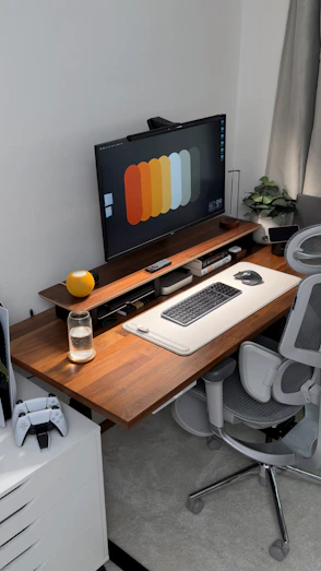 A modern desk setup with computer and gaming accessories.