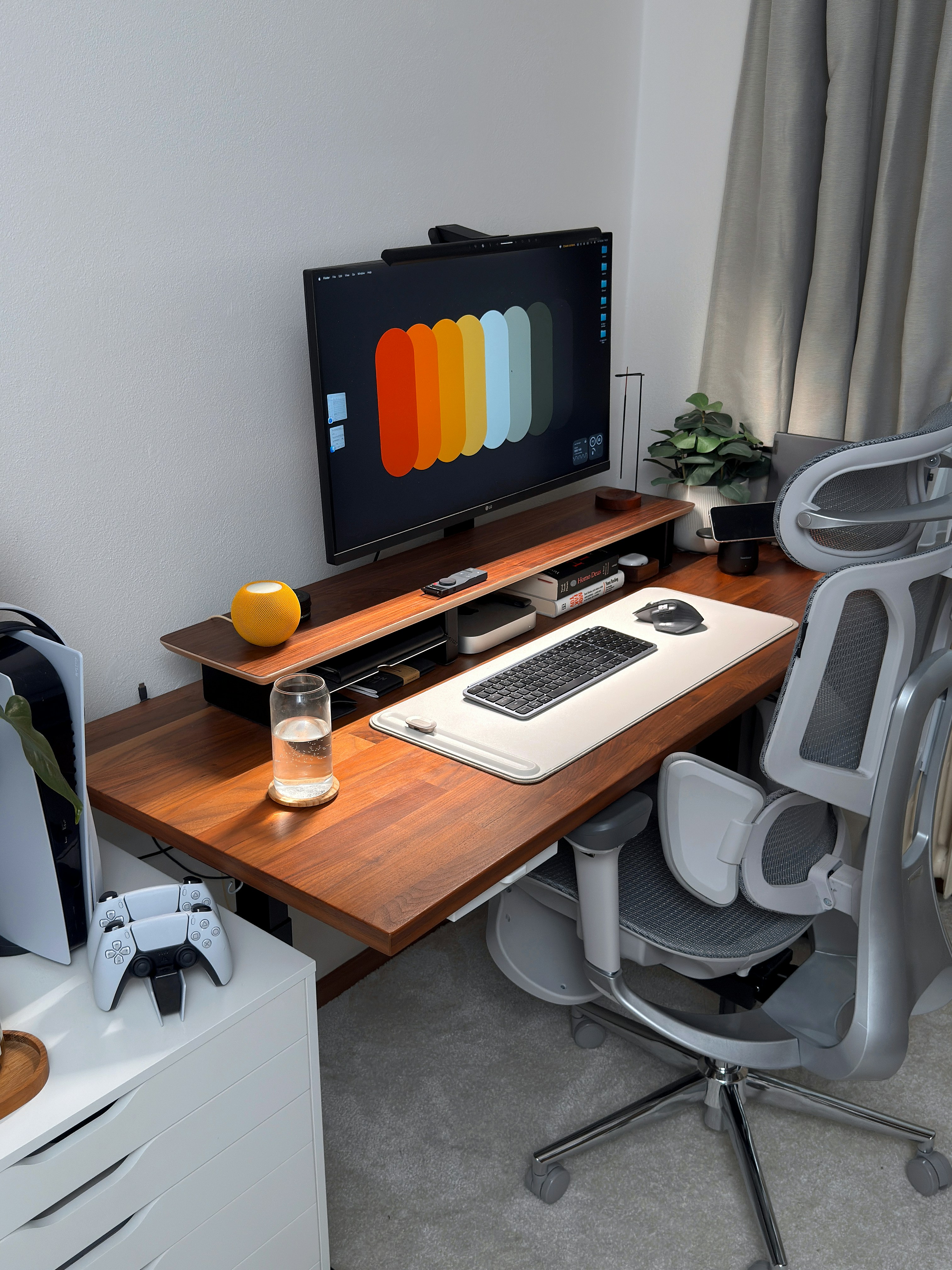 A modern desk setup with computer and gaming console.