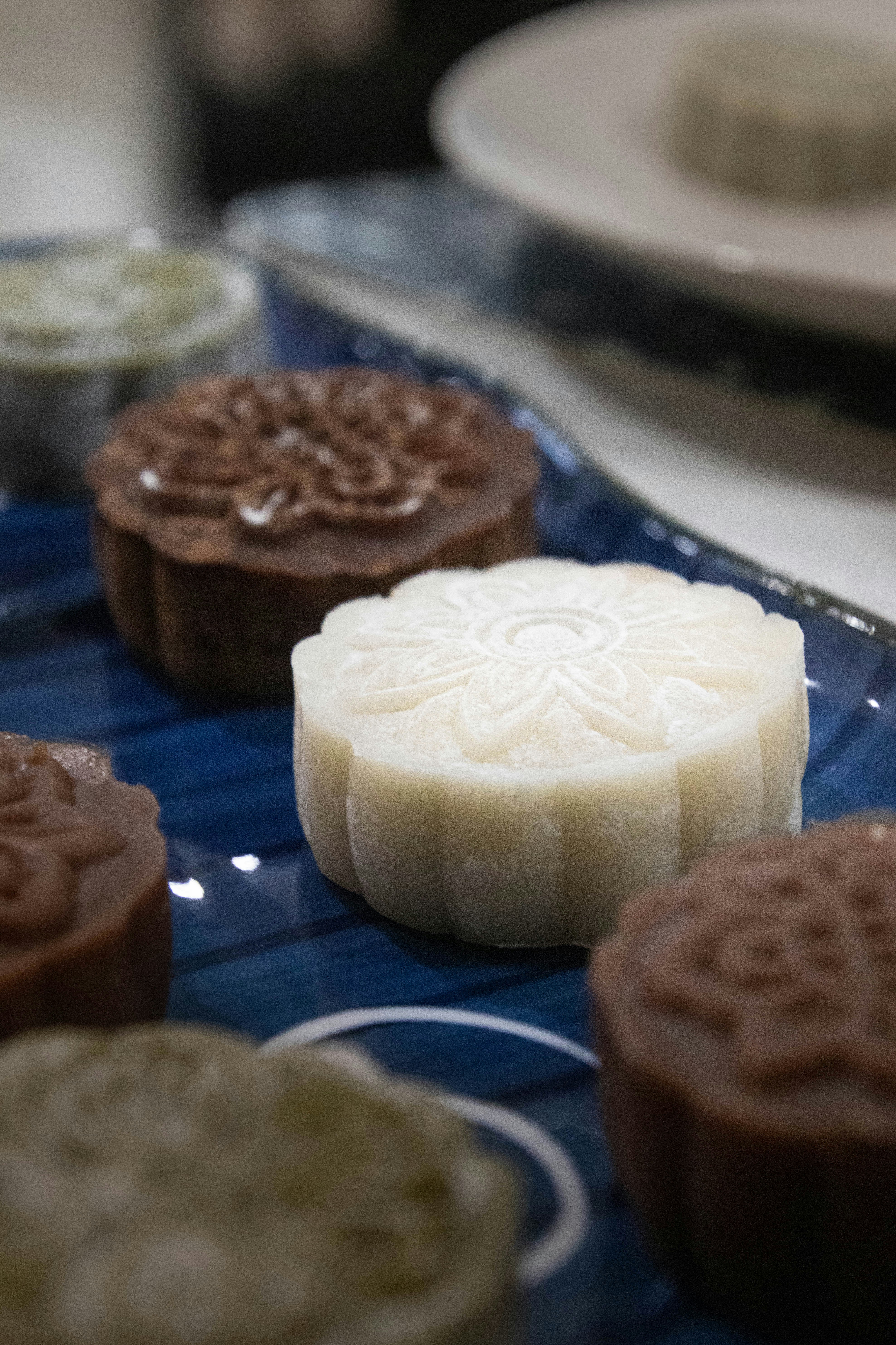 Assortment of decorative mooncakes on a blue plate