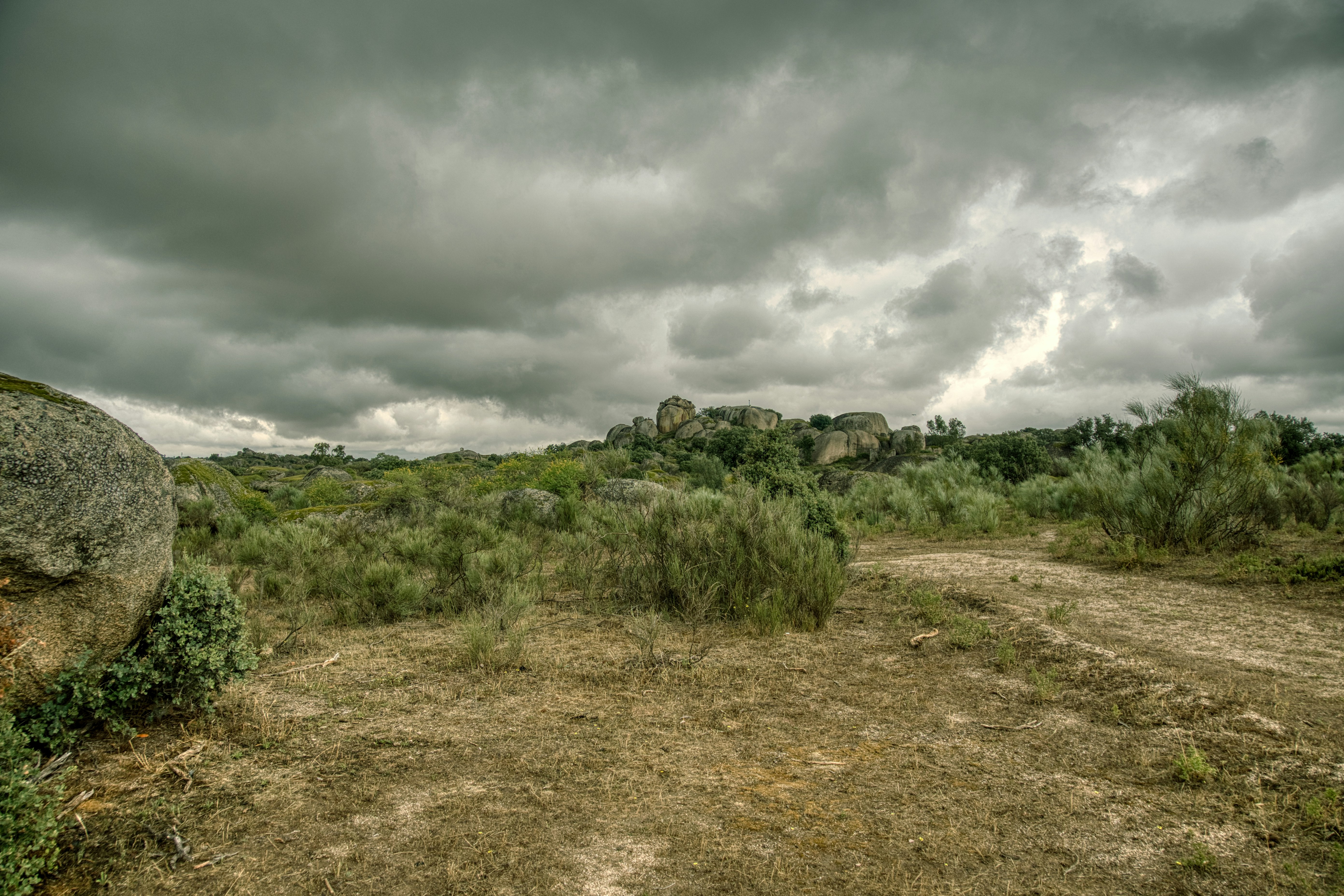 Overcast sky above a rocky, scrubland landscape.