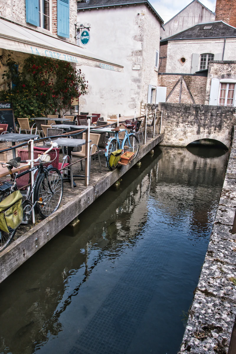 Bicycles parked at a canal-side cafe