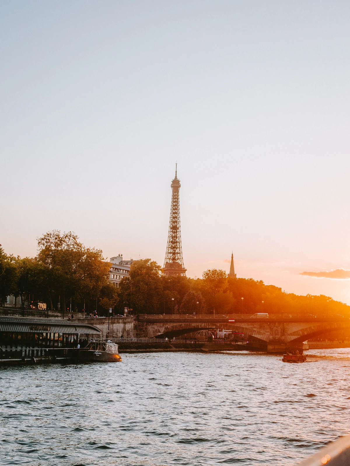 Sunset over the Seine River in Paris with warm golden light on the water