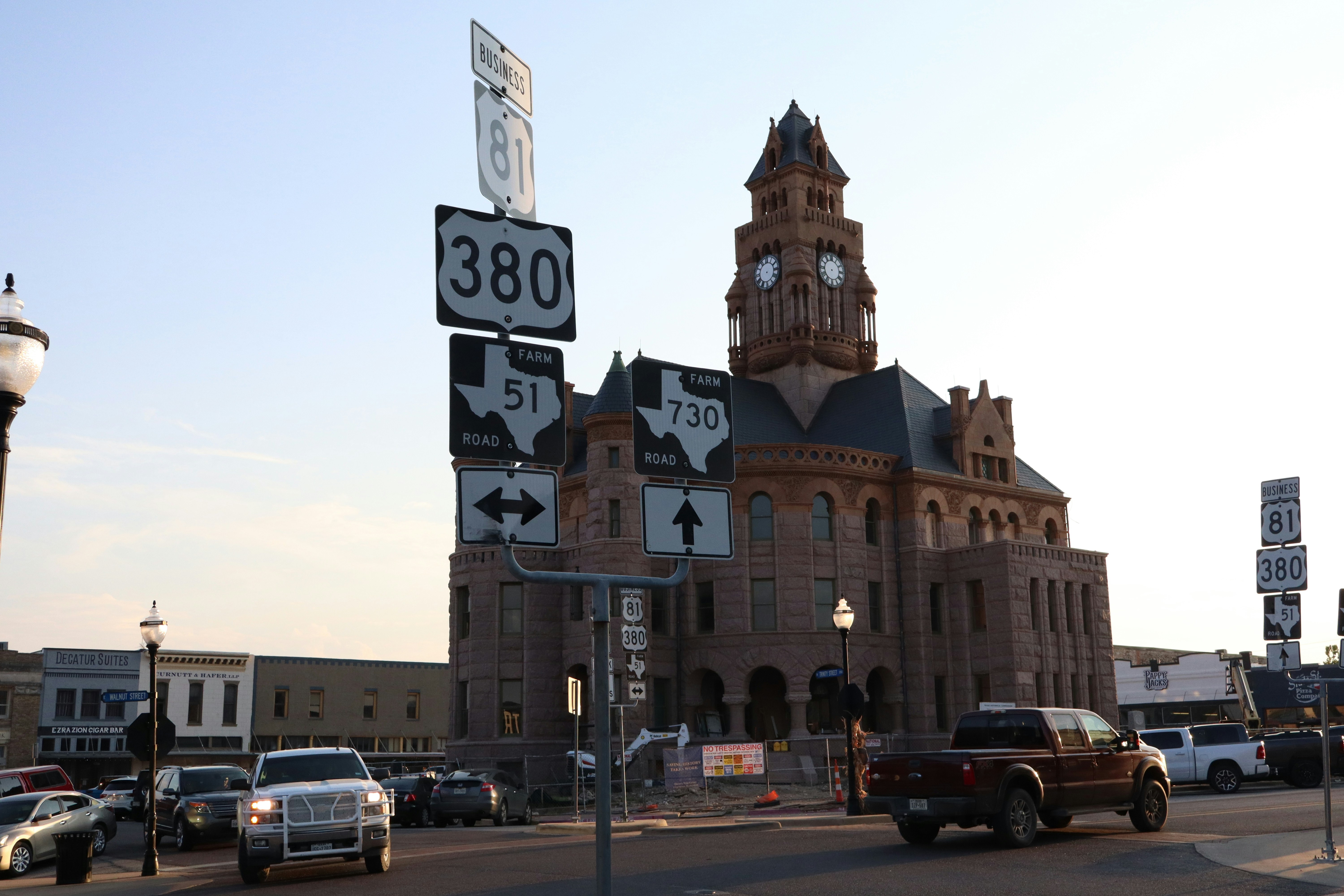 Historic courthouse with road signs in town