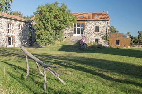 Stone building with large green lawn and trees