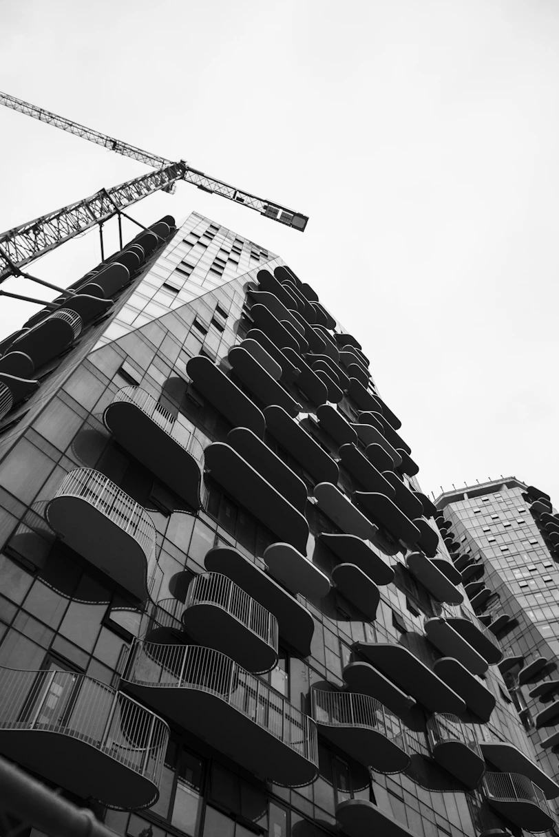 Modern building with balconies and construction crane.