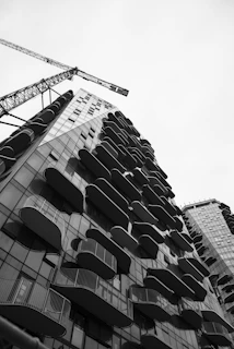 Modern building with balconies and construction crane.