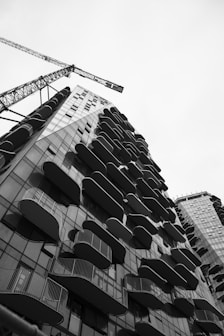 Modern building with balconies and construction crane.