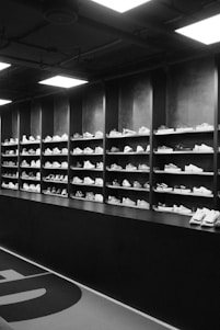 Rows of sneakers displayed on shelves in a store.