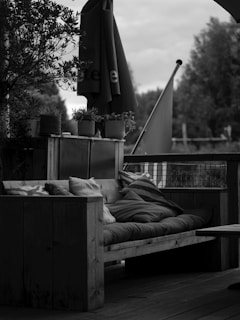 Wooden outdoor sofa with cushions and umbrella