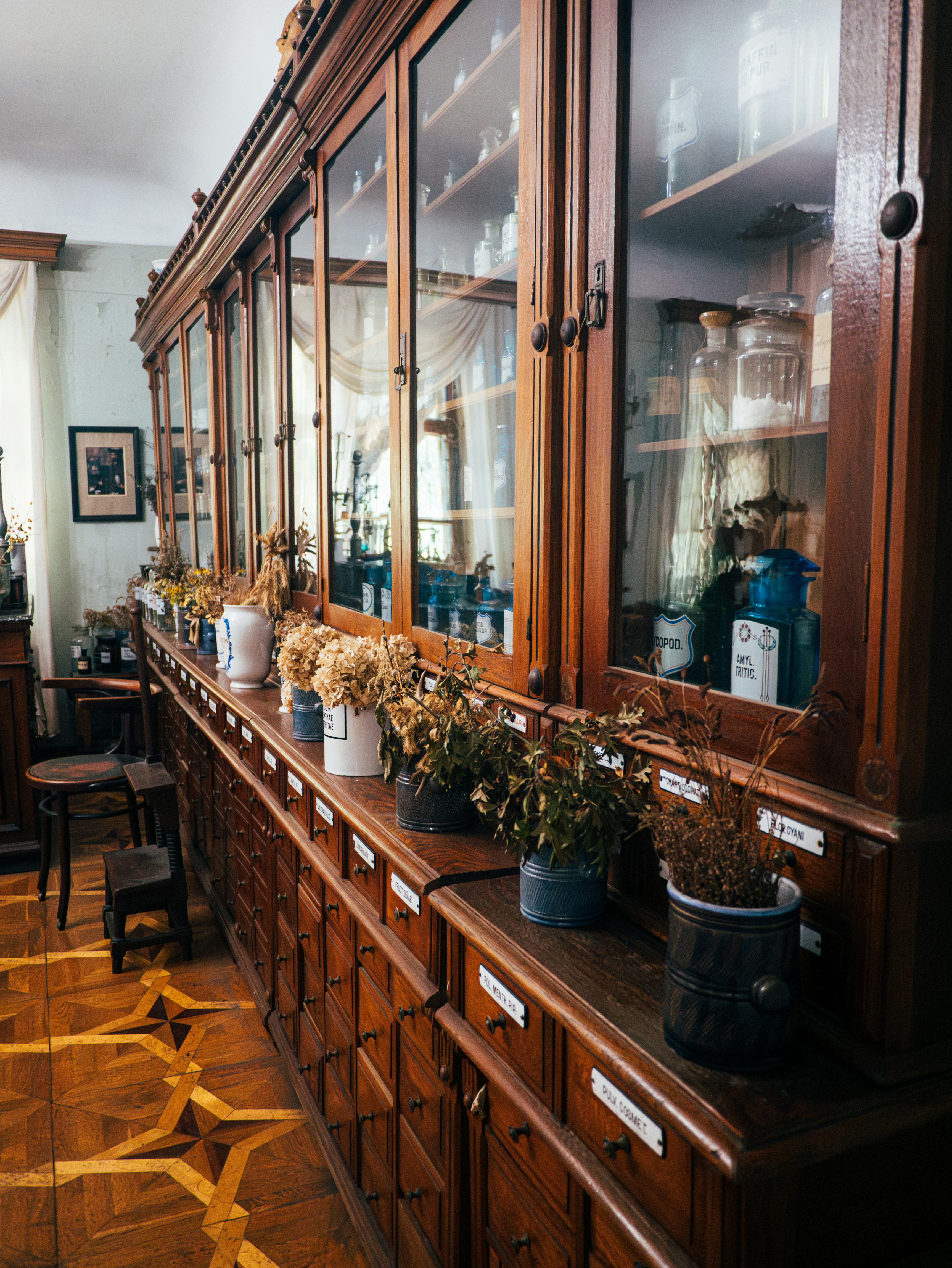Antique wooden apothecary cabinet with glass jars.
