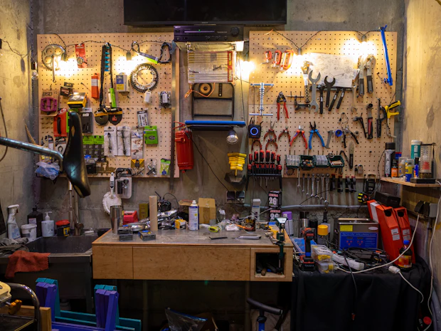 Bike workshop wall with tools, workbench, and maintenance accessories