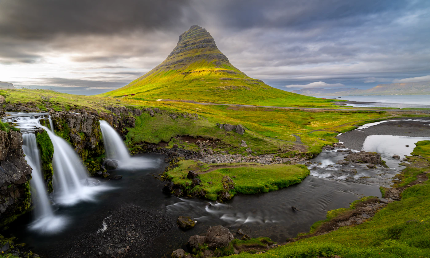 Kirkjufell mountain beside its waterfall at sunset on the Snæfellsnes Peninsula